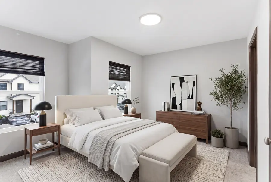 Staged bedroom with a light upholstered bed