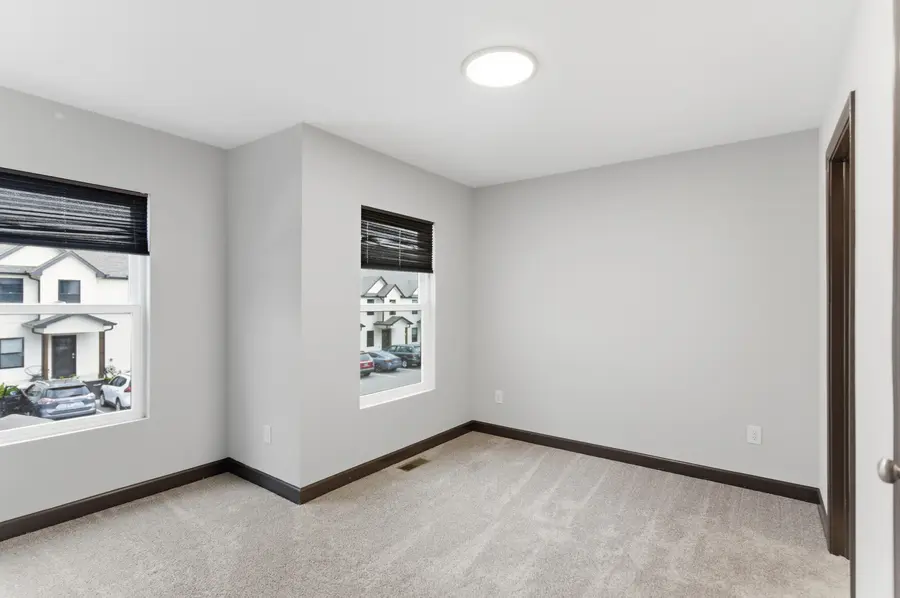 Carpeted bedroom with two windows