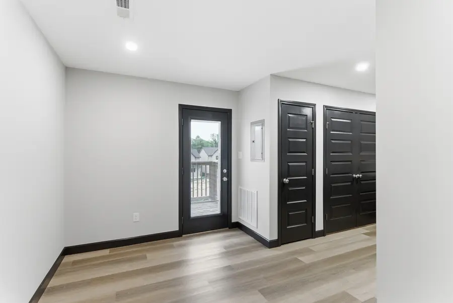 Dining area beside a glass rear door and double closet