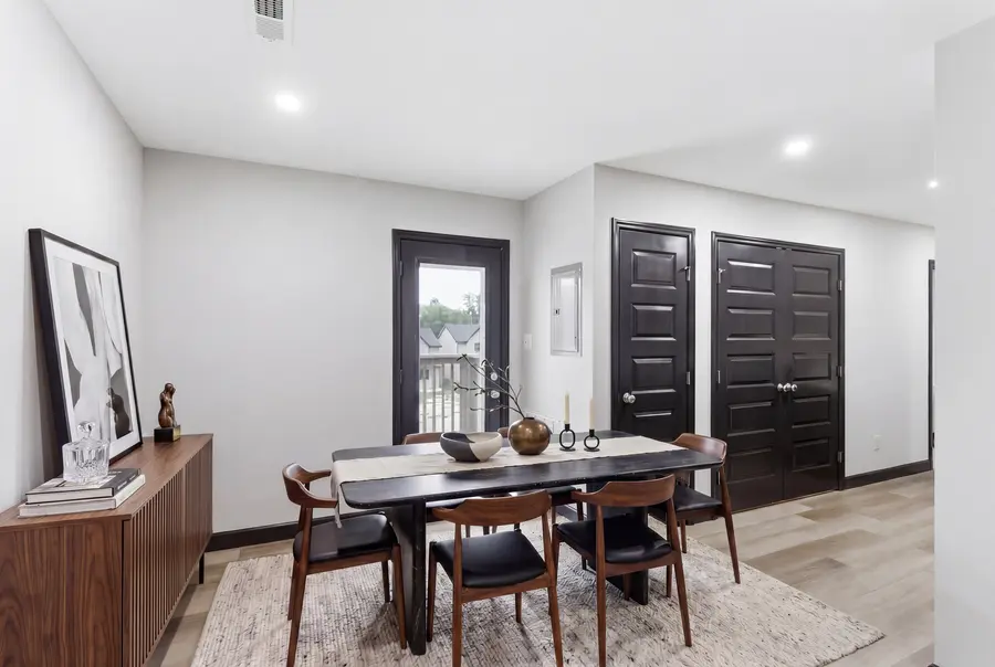 Staged dining table on a rug beside the rear door