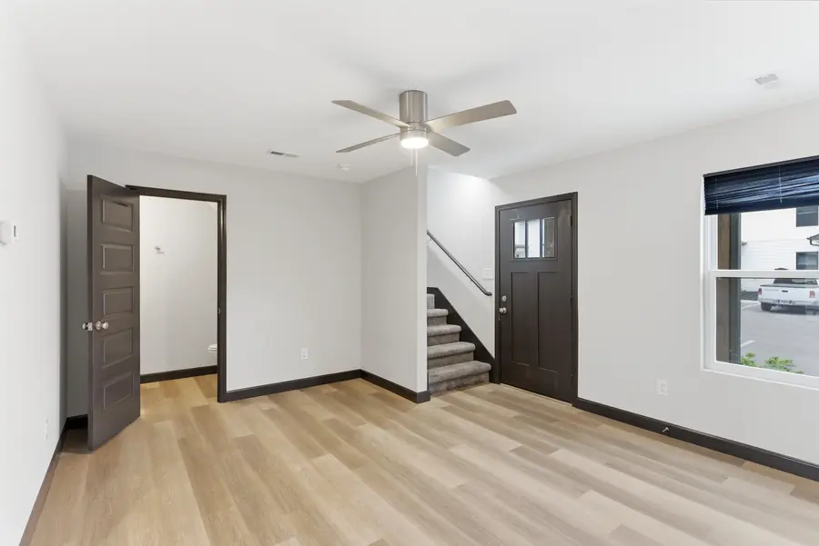 Living area with the front door and staircase