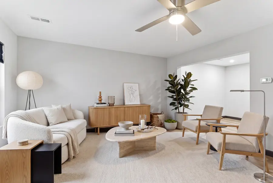 Staged townhome living room with lounge chairs and a coffee table