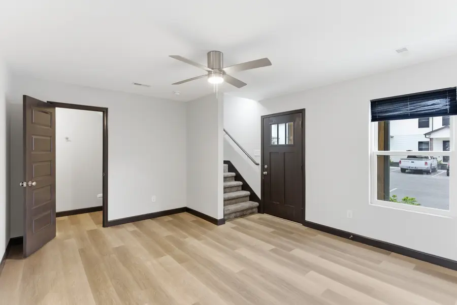 Townhome living area with the staircase and front door