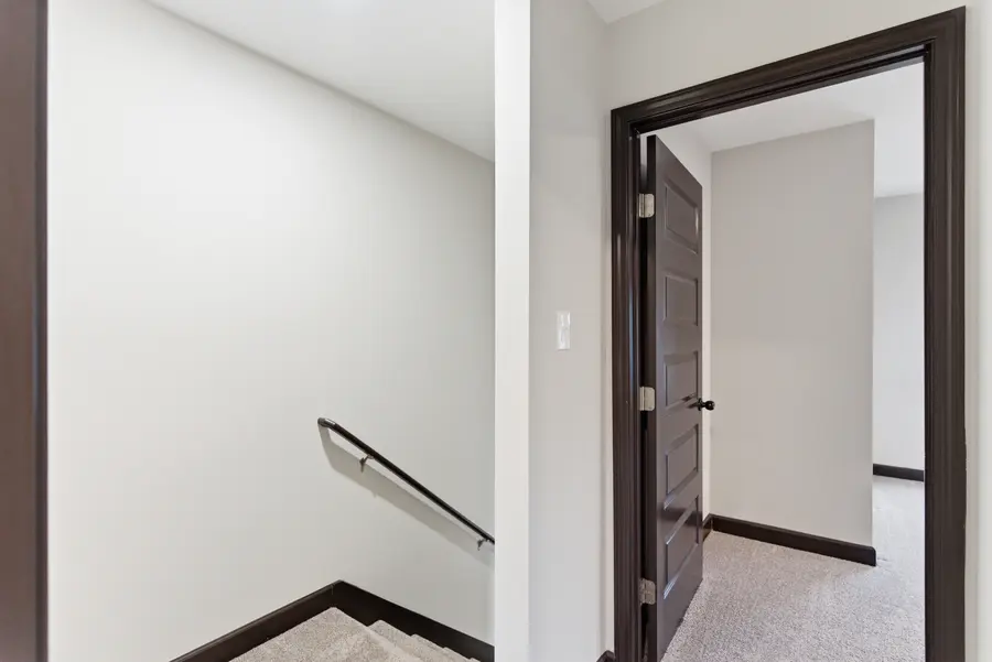 Upstairs landing with the stair rail and bedroom door