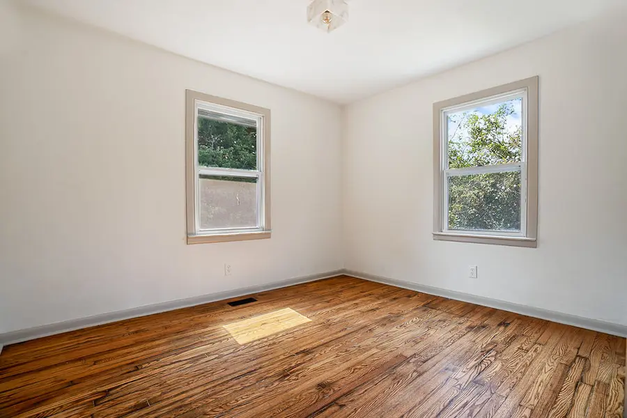 Corner bedroom with hardwood floors