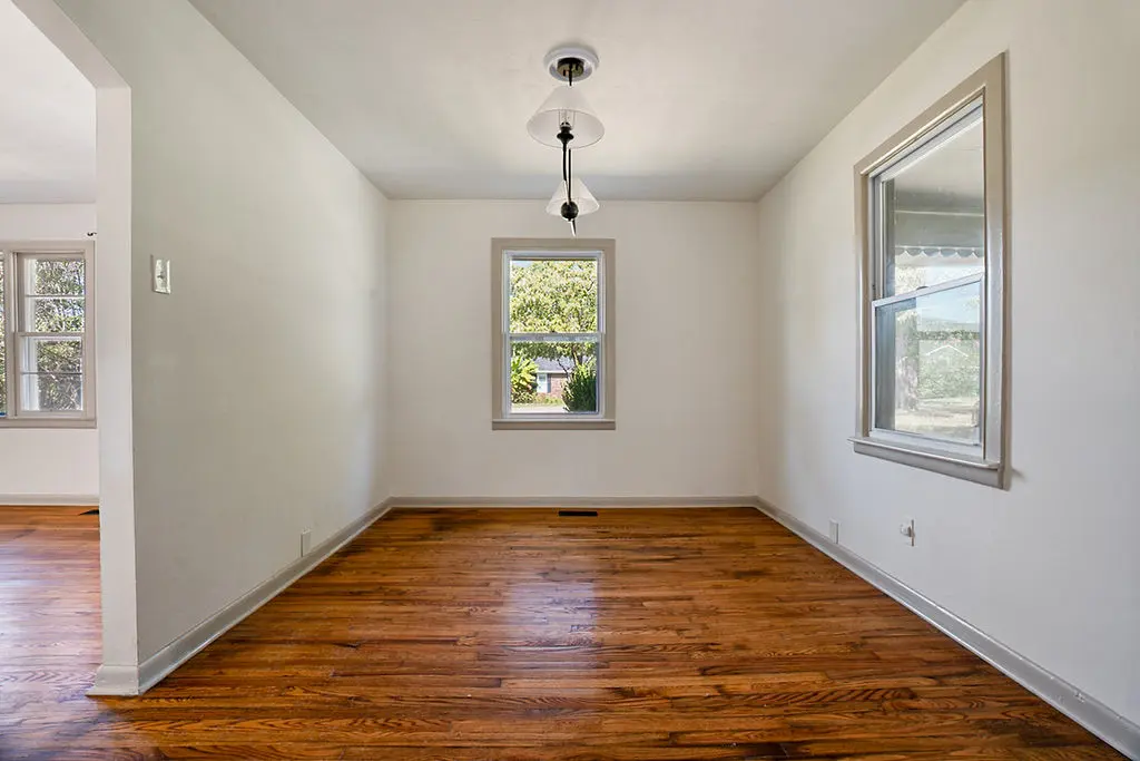 Dining room with hardwood floors and a pendant light