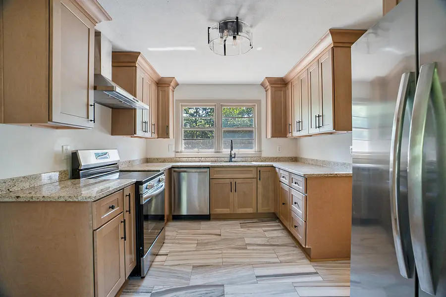 Kitchen with shaker cabinets, granite counters and stainless appliances