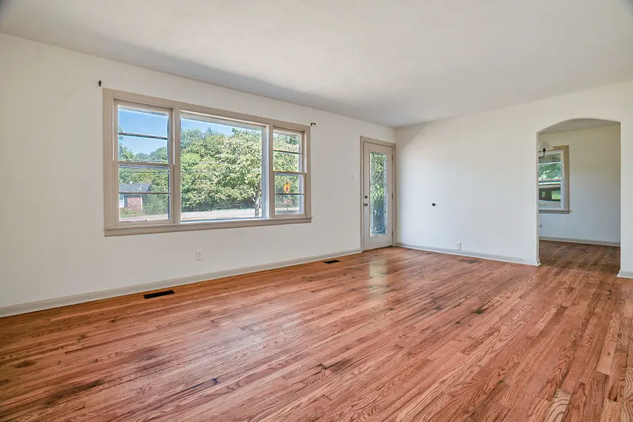 Living room with hardwood floors and an arched doorway