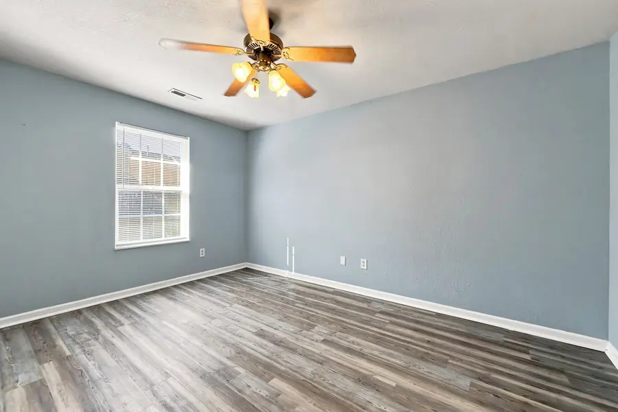 Bedroom with grey walls and a ceiling fan
