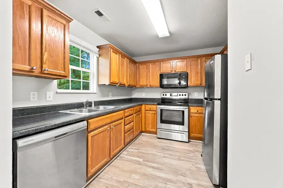 Kitchen with oak cabinets and stainless appliances