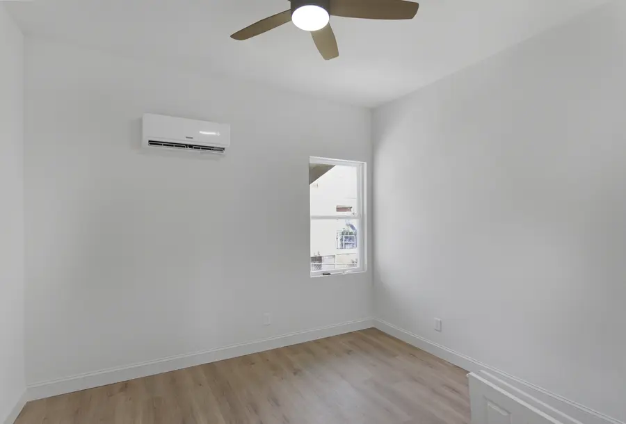 Bedroom with a ceiling fan and a mini-split