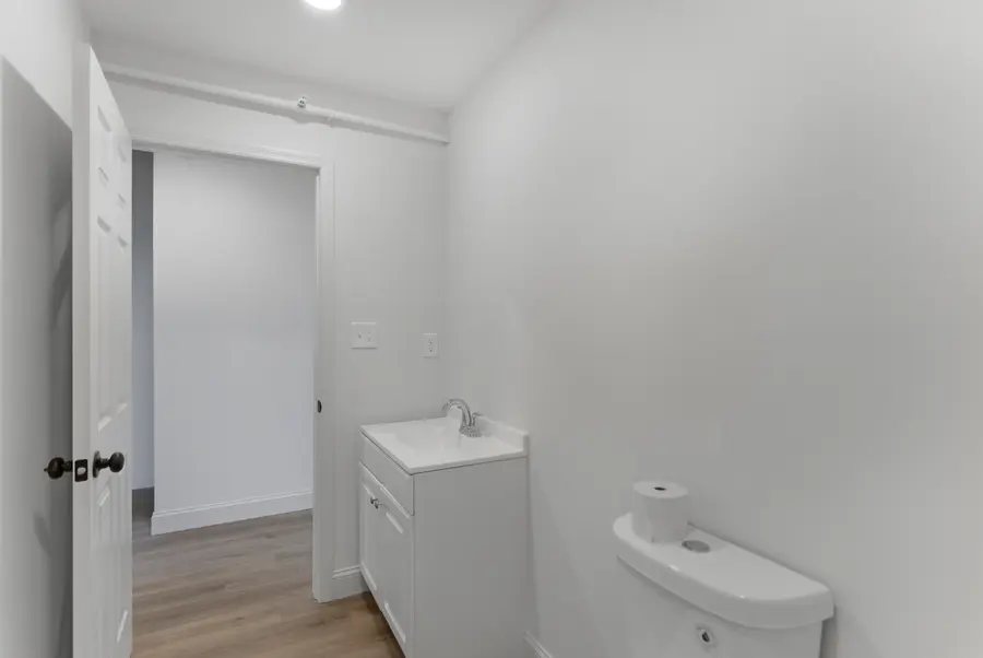 Half bath with a white vanity