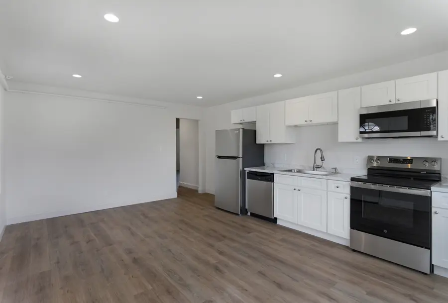 Open kitchen and living area with stainless appliances
