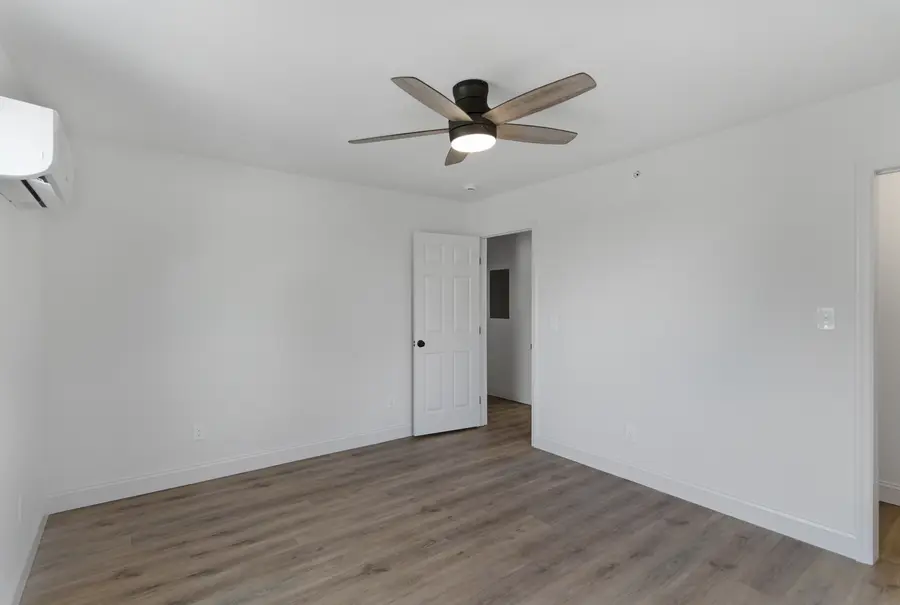 Unit living room with a ceiling fan and a mini-split