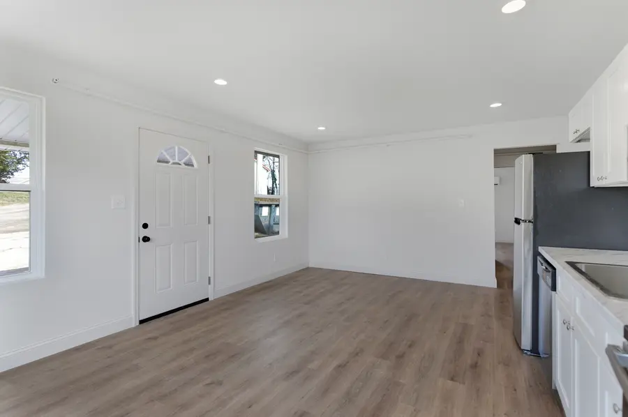Living area with the front door and plank floors