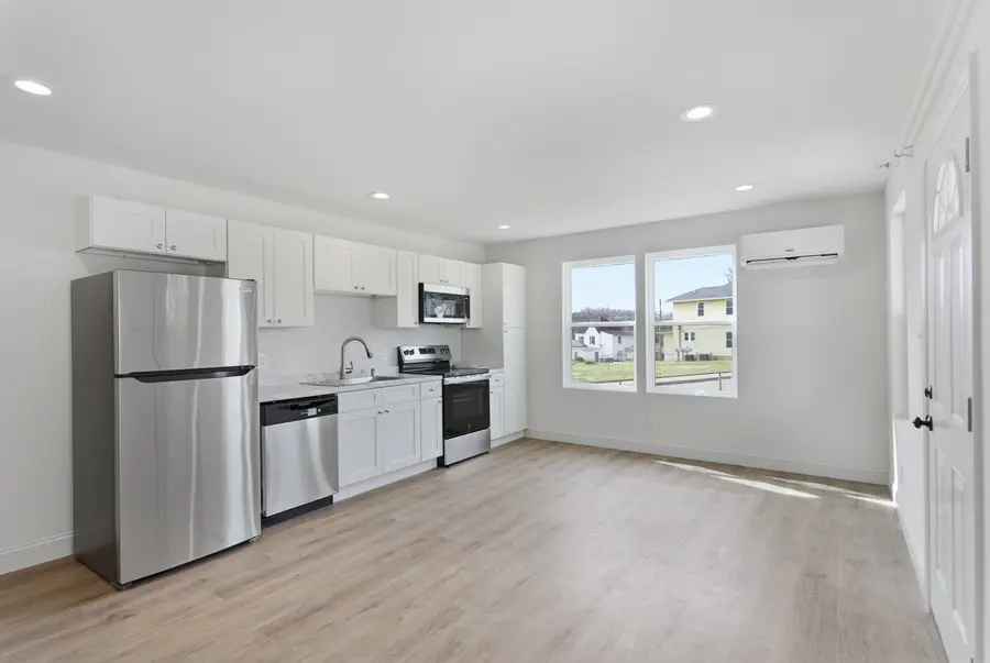 Open kitchen and living room with stainless appliances