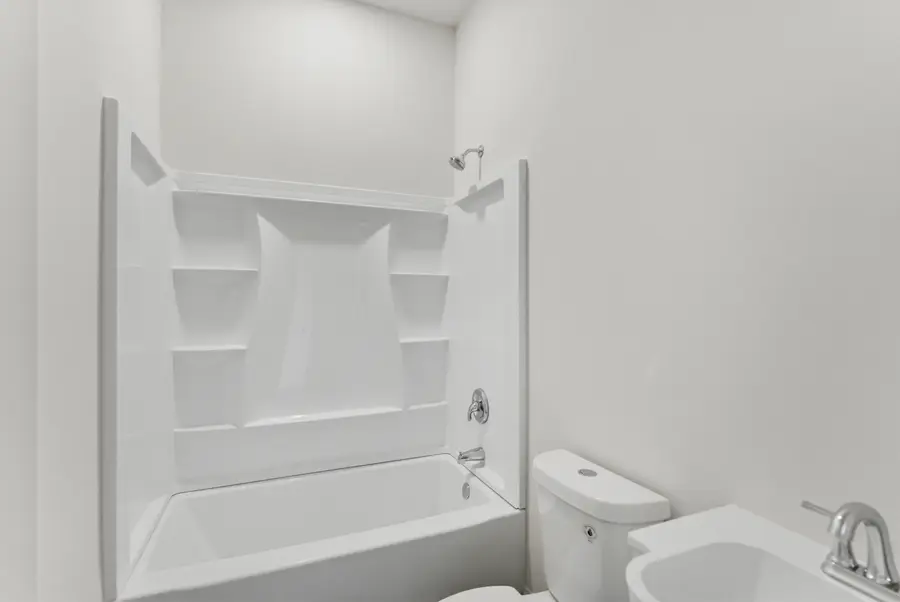 Bathroom with a tub shower and toilet