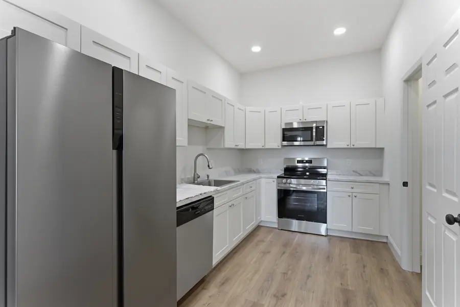 White kitchen with stainless appliances