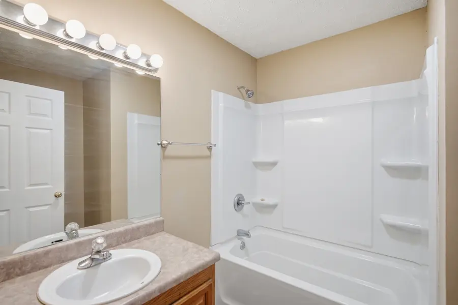 Bathroom with a tub shower and vanity