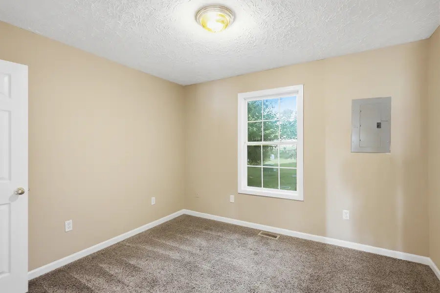 Carpeted bedroom with a window