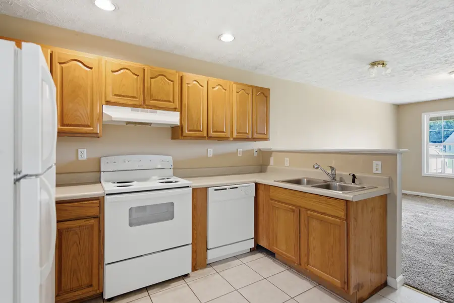 Kitchen with oak cabinets and white appliances