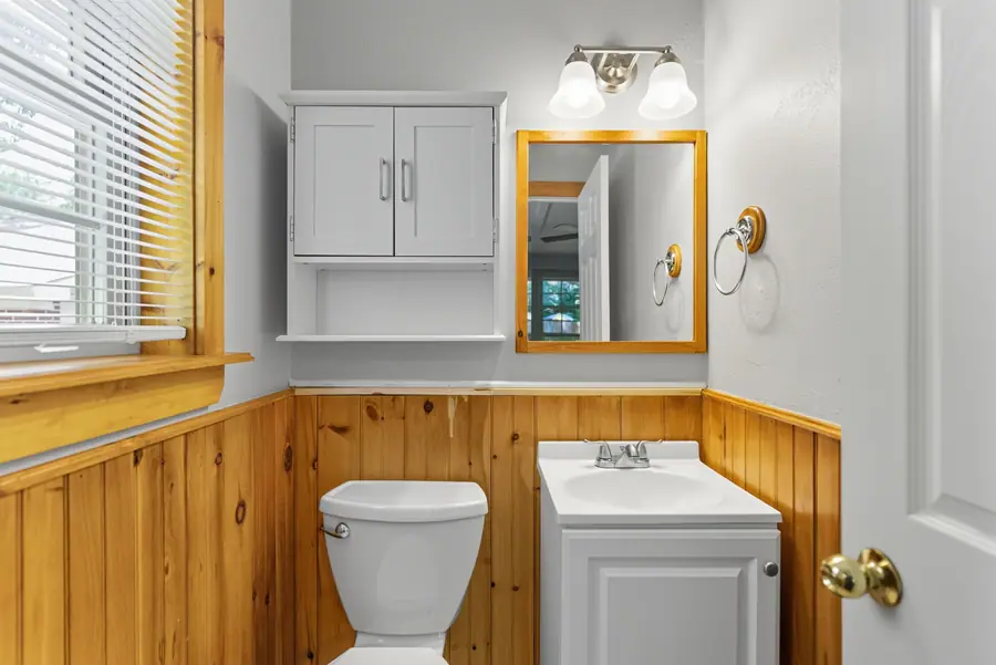 Bathroom with cedar wainscot and a mirrored cabinet