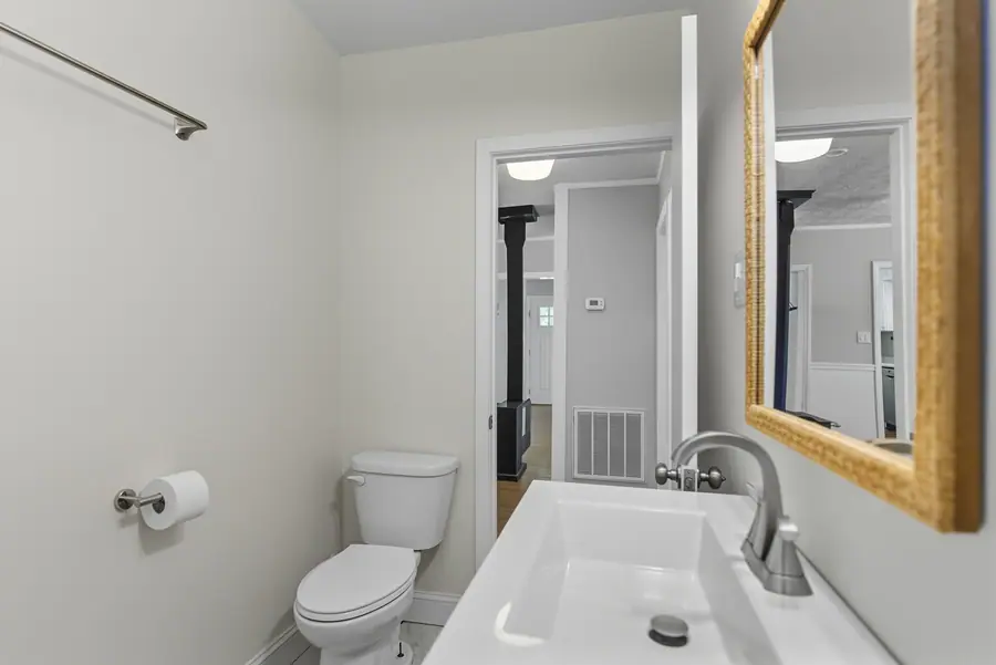Bathroom with a framed mirror and tub surround