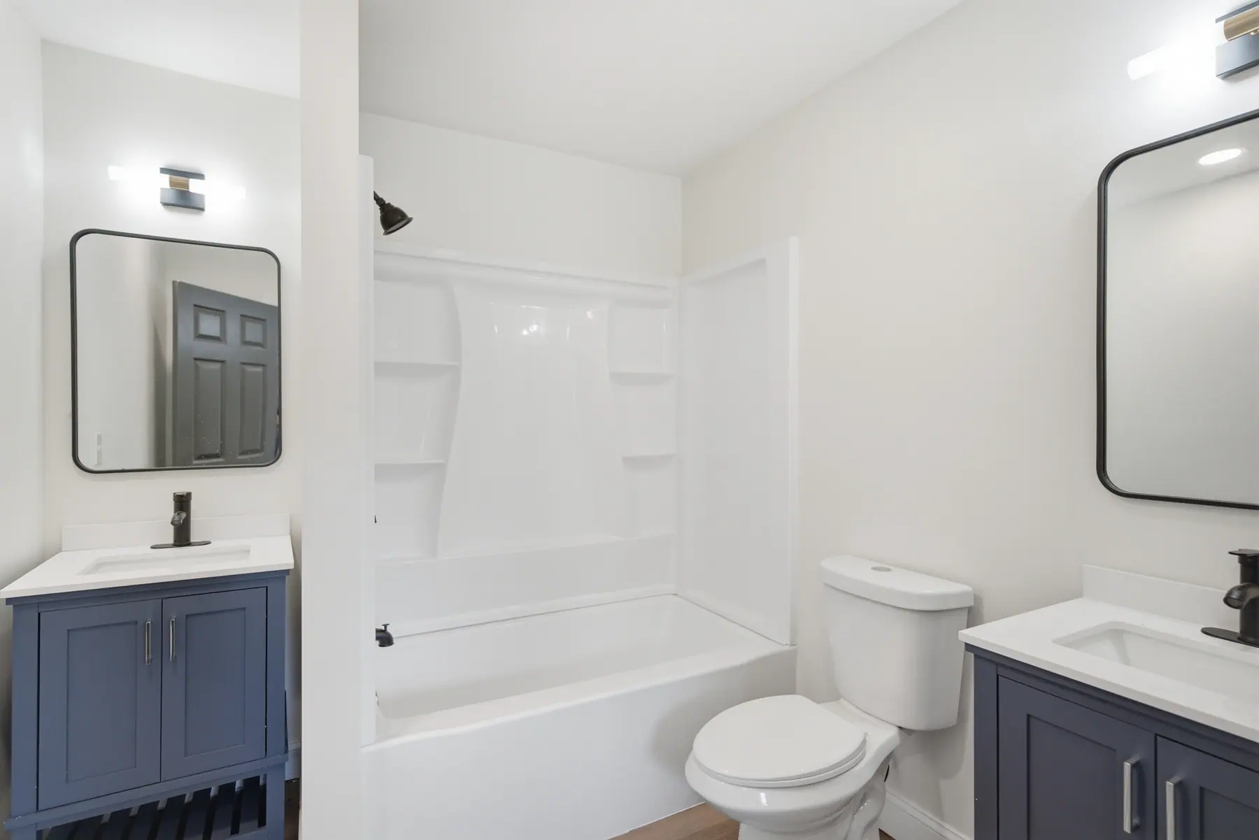 Bathroom with a full tub and shower surround