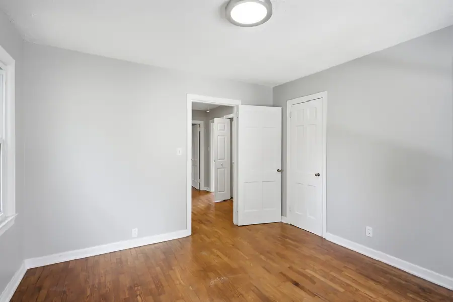 Bedroom with a closet and hardwood floors