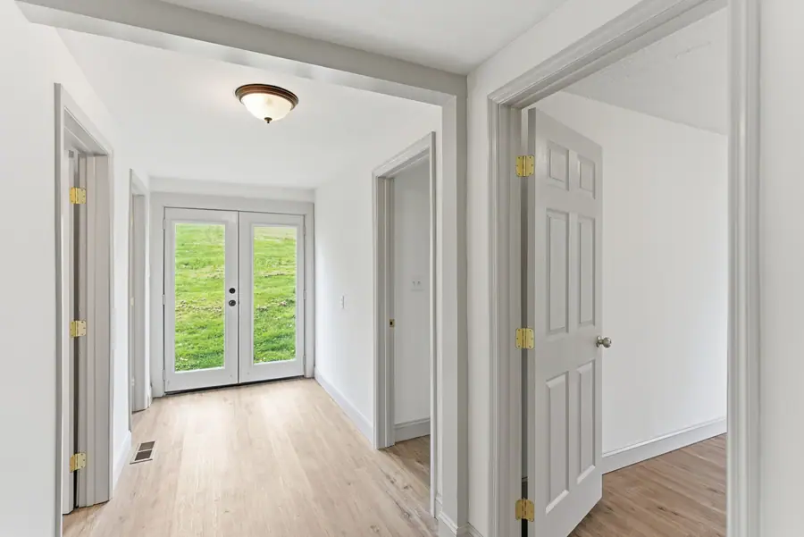 Hallway with French doors opening onto the back yard