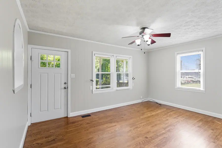 Entry room with the front door and hardwood floors