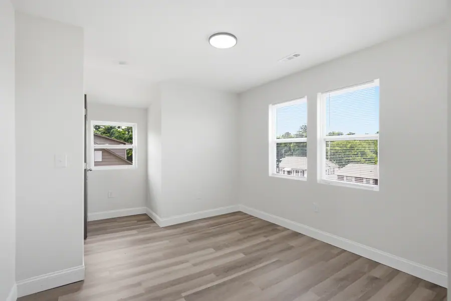 Room with luxury vinyl plank floors and a pair of windows