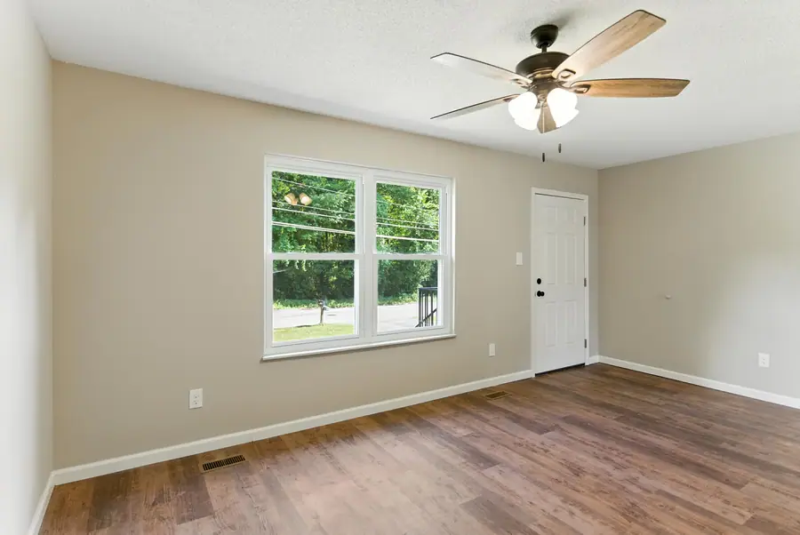 Room with a side entry door and luxury vinyl plank floors