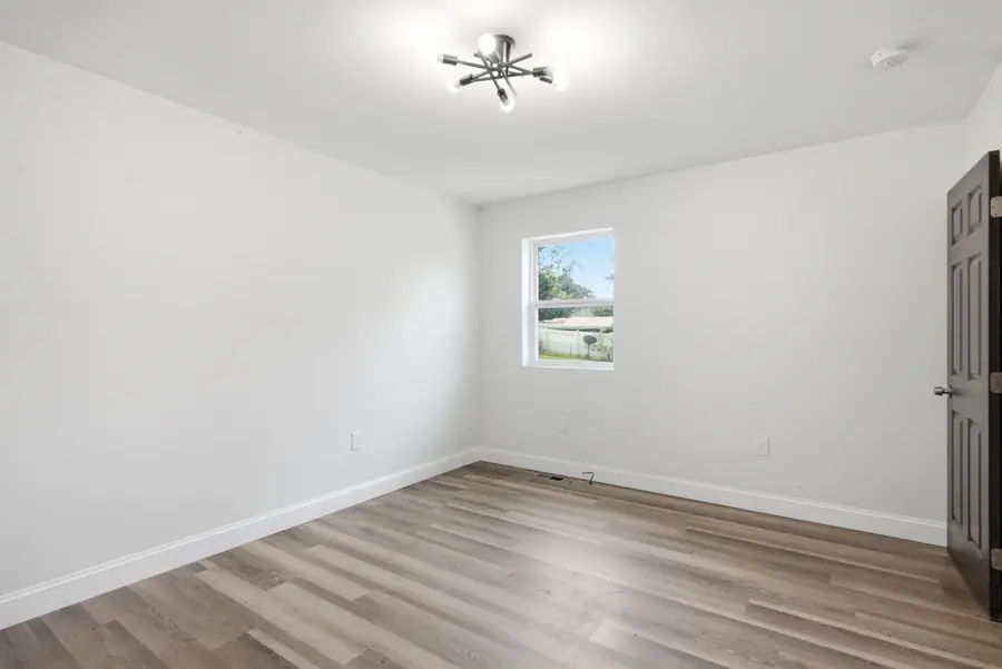 Room with luxury vinyl plank flooring and a window to the yard