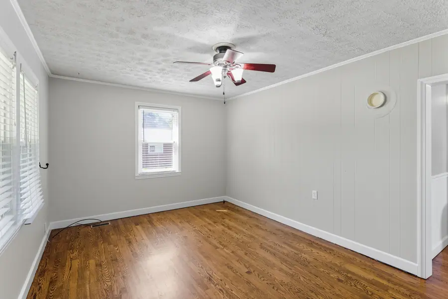 Room with panelled walls and window blinds