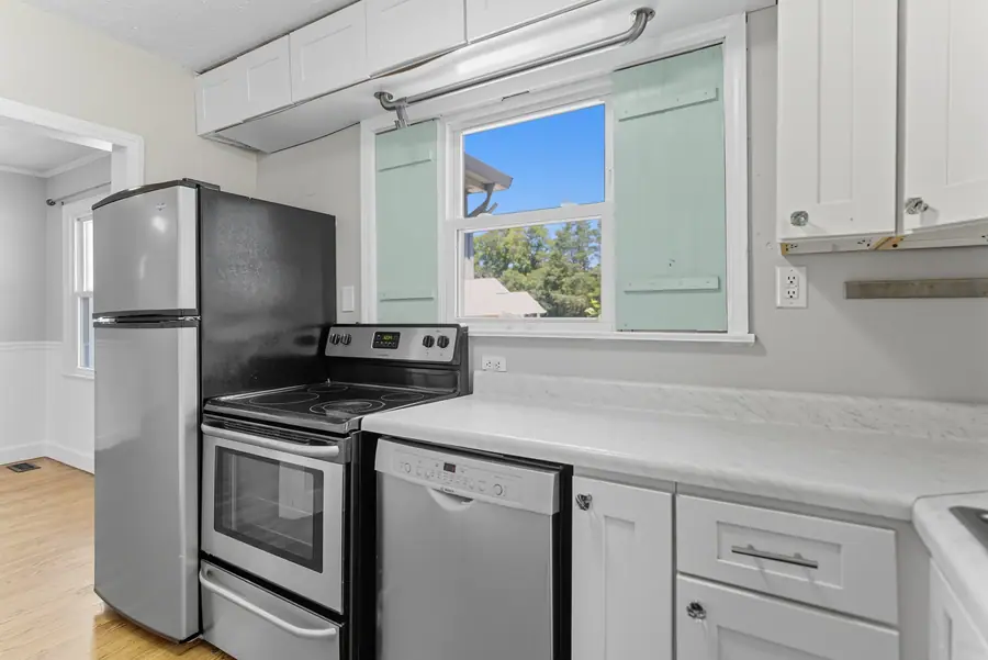 Compact kitchen with a range, dishwasher and window over the counter