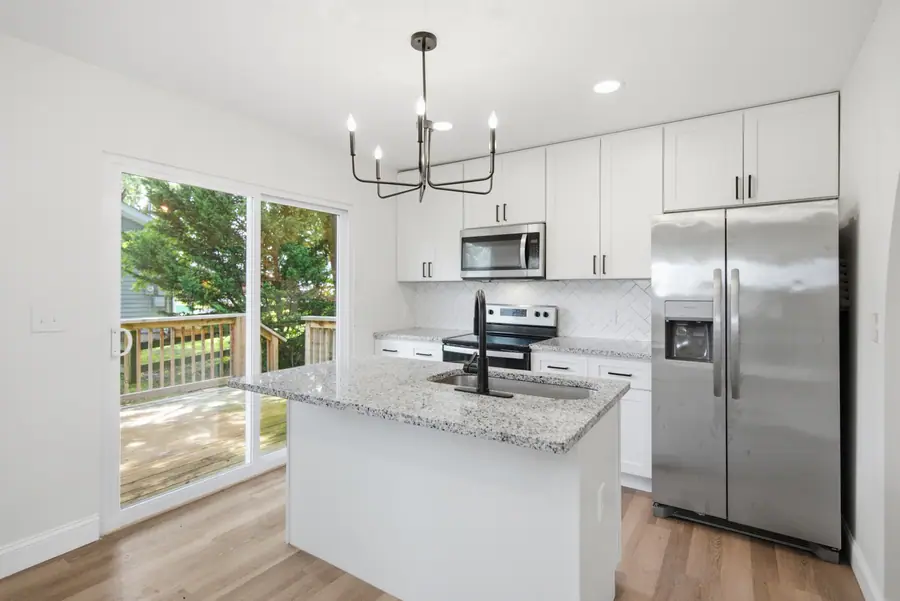 Granite island kitchen with stainless steel appliances