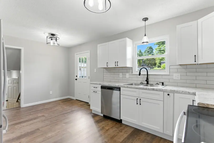 White kitchen with subway tile and a farmhouse sink