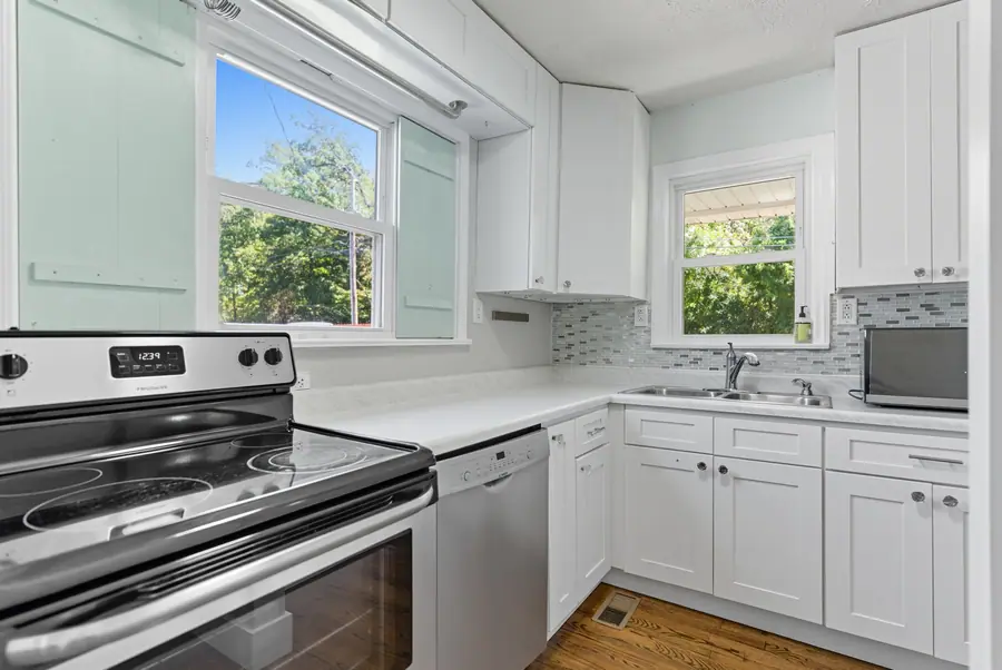 Bright white kitchen with a window over the sink
