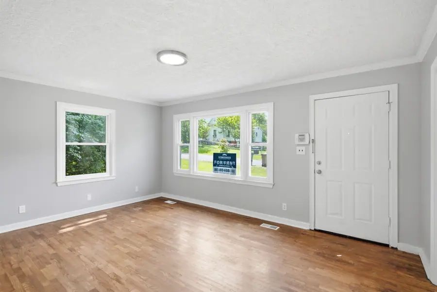 Living room of a rental listed for rent, with refinished hardwood floors