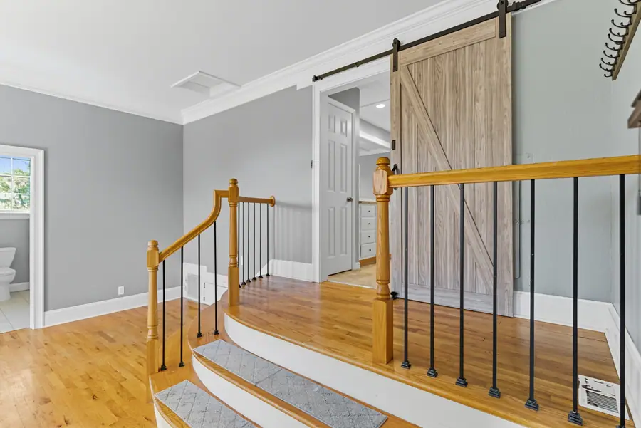 Staircase landing with a sliding barn door