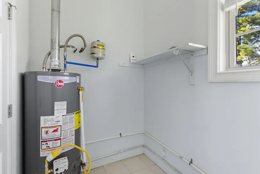 Utility room with the water heater and shelving